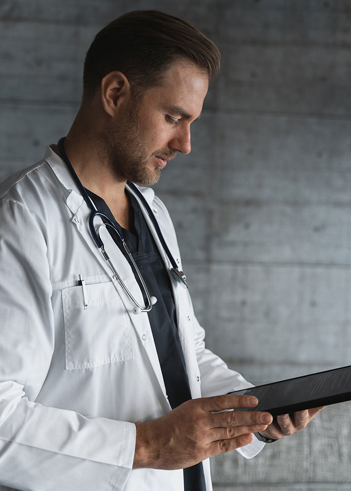 busy perplexed male doctor in white robe